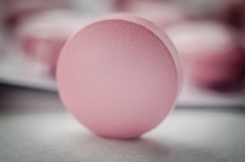 Close-up of a pink medicine tablet