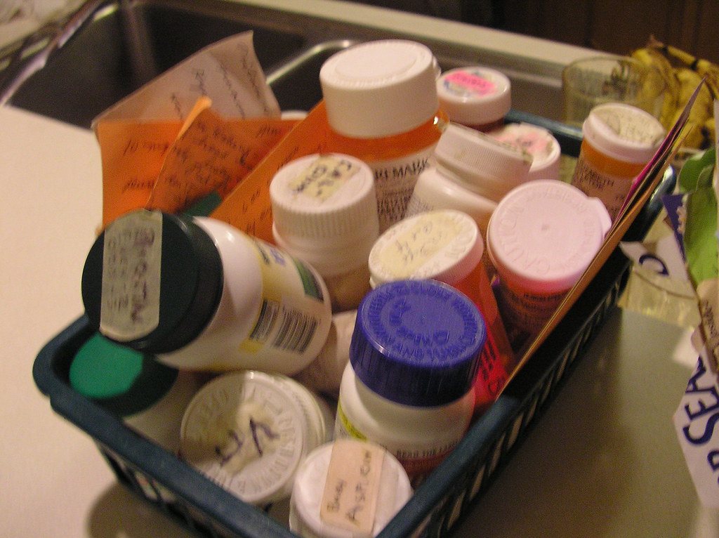 Pill box full of medicine bottles and tablets