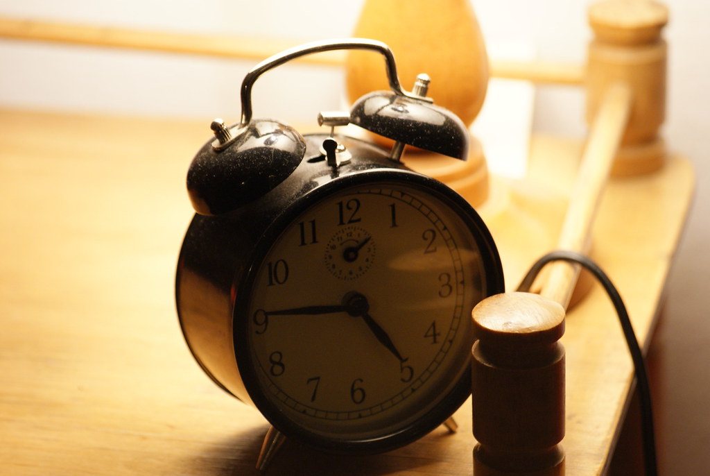 Classic twin-bell alarm clock on a wooden table