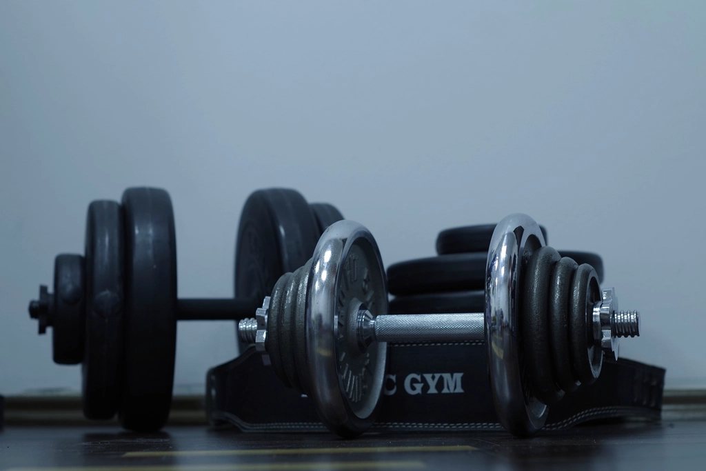 Rack of black dumbbells in a gym
