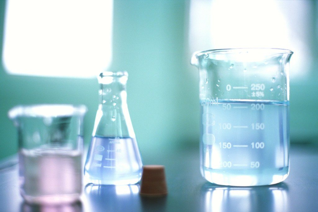 Laboratory glassware with clear liquids on a bench