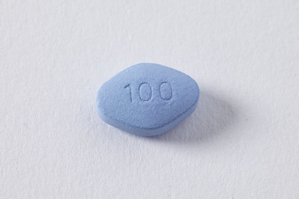 Single blue diamond-shaped tablet on white
