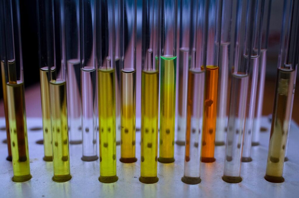 Rack of glass tubes holding amber and clear solutions
